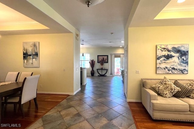 interior space featuring dark hardwood / wood-style floors, ornamental molding, and a tray ceiling