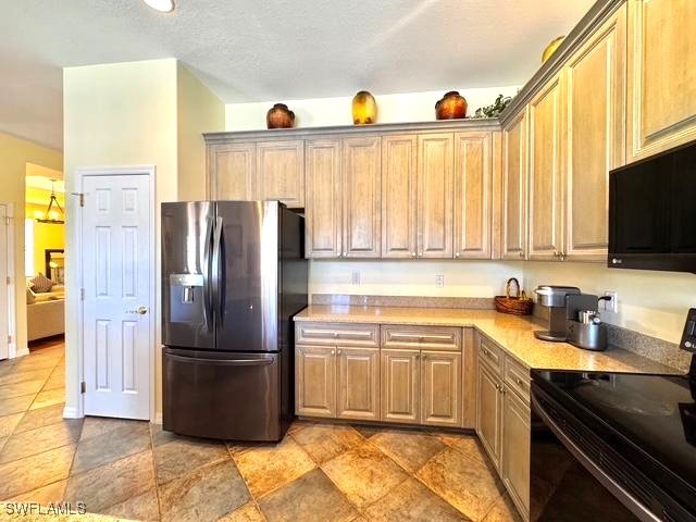 kitchen with stainless steel fridge with ice dispenser and electric range