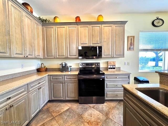 kitchen with stainless steel appliances and light stone countertops