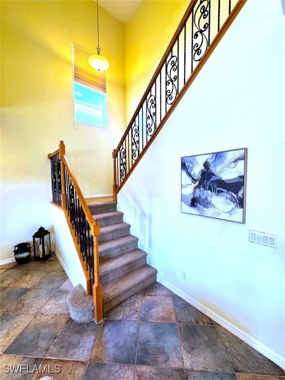 stairs featuring a towering ceiling