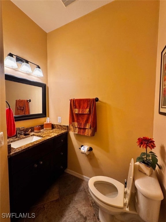 bathroom with vanity, tile patterned floors, and toilet