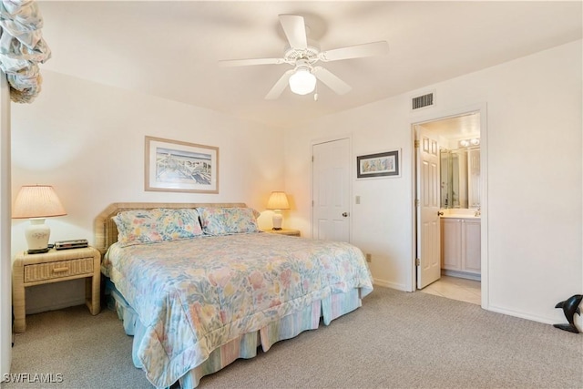 carpeted bedroom with ceiling fan and ensuite bathroom