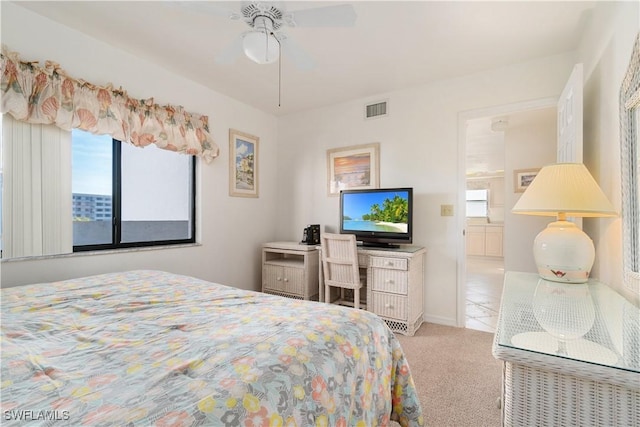 carpeted bedroom with ceiling fan and multiple windows