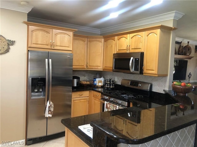 kitchen with ornamental molding, appliances with stainless steel finishes, kitchen peninsula, and dark stone countertops