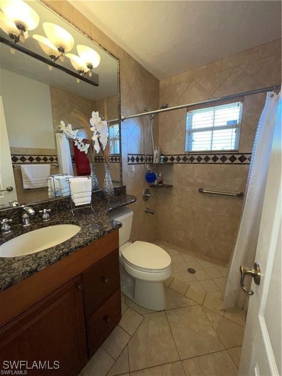 bathroom featuring tile patterned floors, vanity, toilet, and a shower with shower curtain