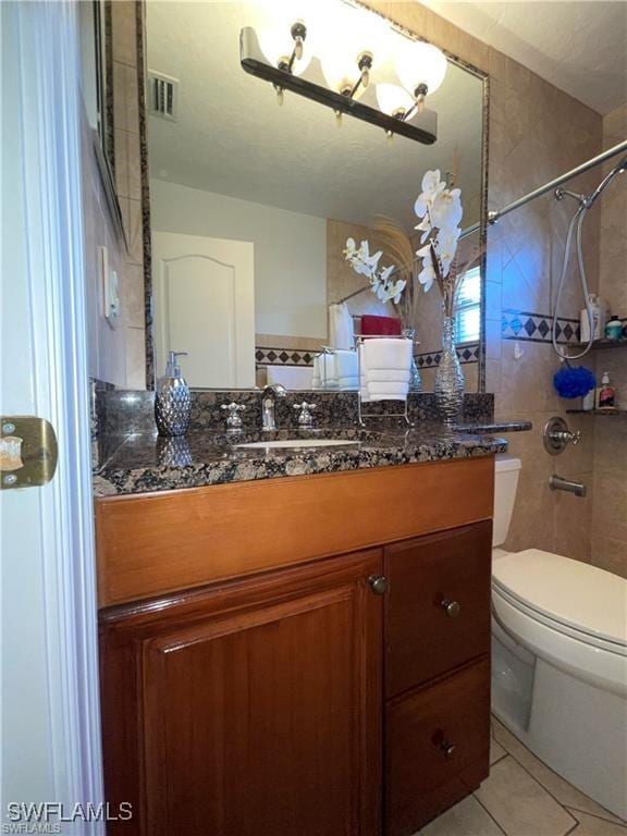 bathroom with vanity, toilet, and tile patterned flooring