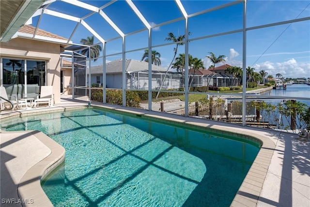 view of swimming pool featuring a water view, glass enclosure, and a patio area