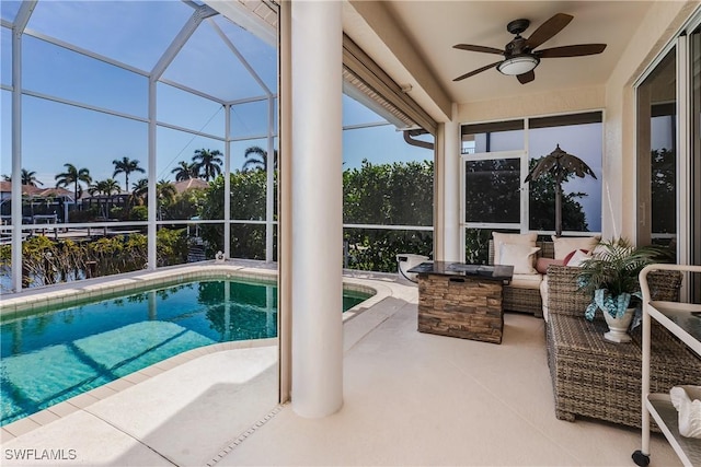 view of swimming pool featuring a patio, area for grilling, a lanai, ceiling fan, and an outdoor living space