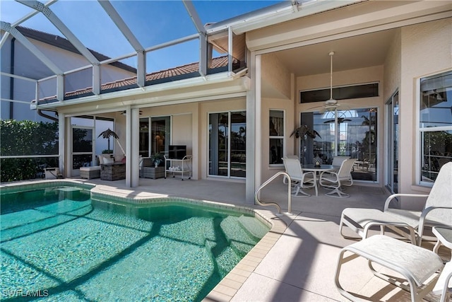 view of pool featuring a lanai, a patio, and ceiling fan