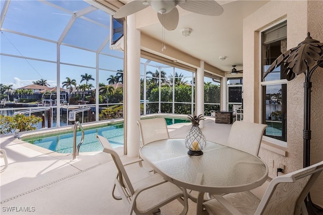 sunroom with a swimming pool and a water view