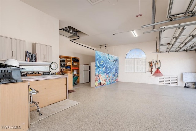 garage featuring white fridge