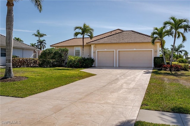 mediterranean / spanish-style house featuring a garage and a front yard