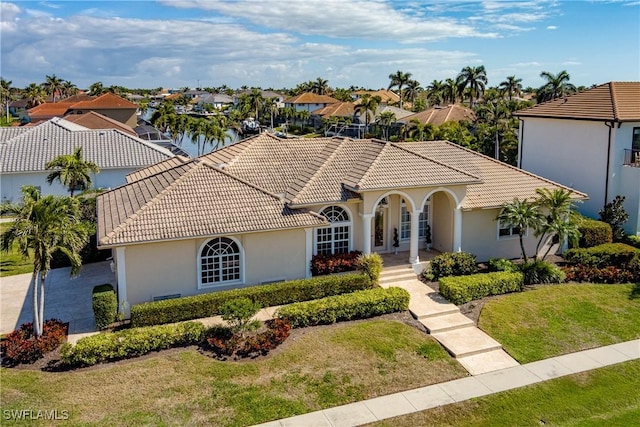 mediterranean / spanish-style home featuring a water view and a front yard