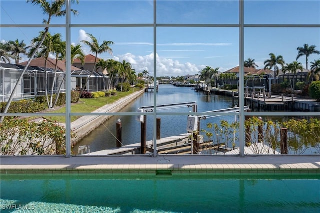 view of pool with a dock and a water view