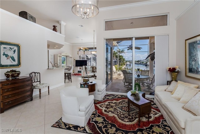 living room with light tile patterned floors, crown molding, and ceiling fan with notable chandelier