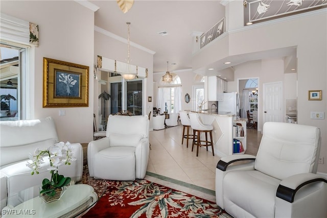 living room featuring light tile patterned floors, crown molding, and a high ceiling