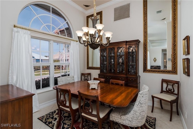 dining room with light tile patterned floors, ornamental molding, and a chandelier