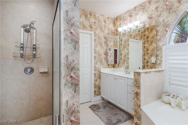 bathroom featuring vanity, tiled shower, and tile patterned floors