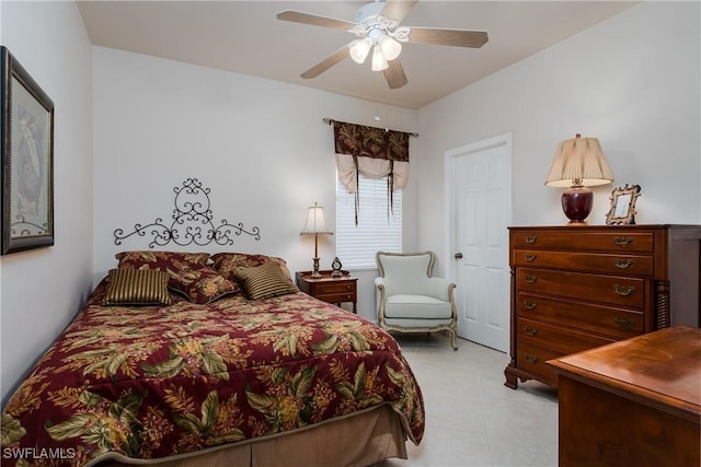 tiled bedroom featuring ceiling fan