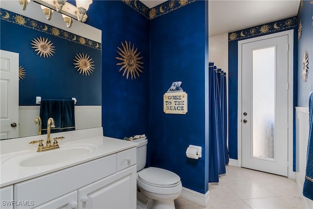 bathroom featuring vanity, tile patterned flooring, and toilet