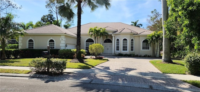 mediterranean / spanish house featuring a front lawn