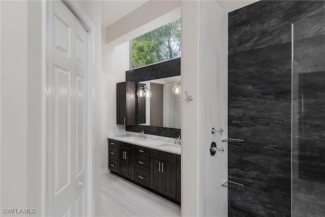 bathroom featuring a high ceiling and vanity