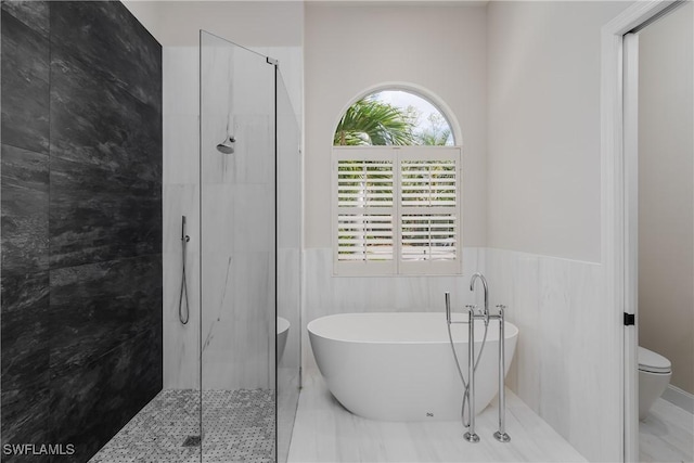 bathroom featuring independent shower and bath, tile walls, and toilet