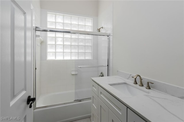 bathroom with enclosed tub / shower combo and vanity