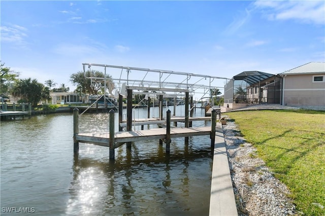 view of dock with a water view, glass enclosure, and a lawn