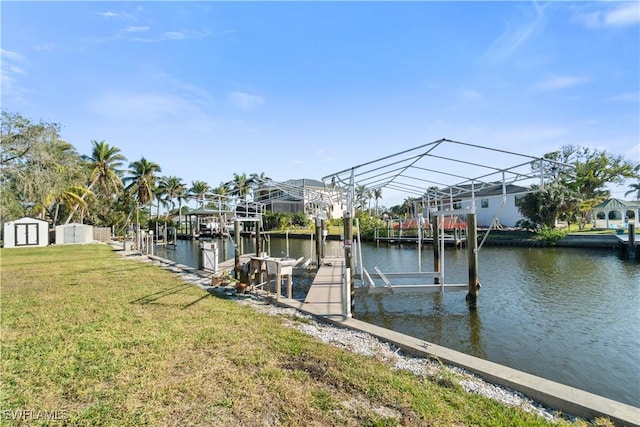 dock area featuring a water view and a lawn