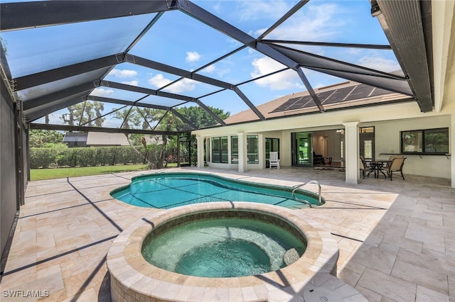 view of swimming pool featuring an in ground hot tub, a lanai, and a patio area