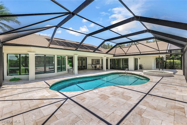 view of swimming pool featuring a lanai, a patio area, and an in ground hot tub