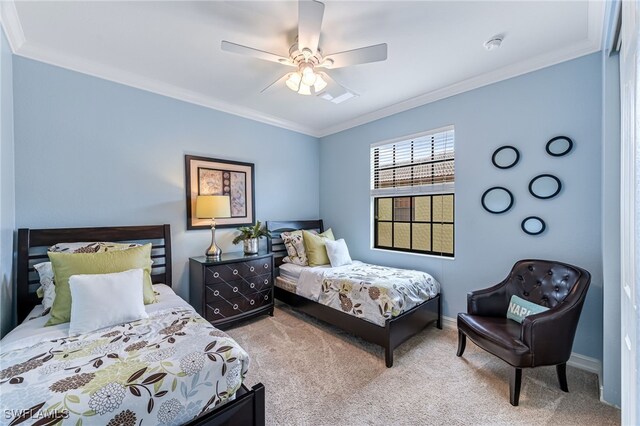 bedroom featuring carpet floors, ornamental molding, and ceiling fan
