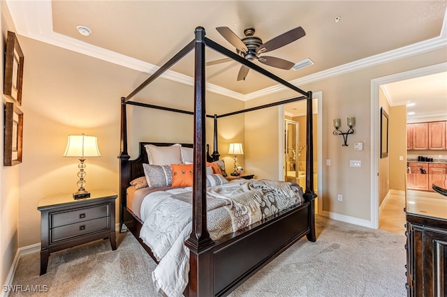 bedroom with ornamental molding, connected bathroom, and light carpet