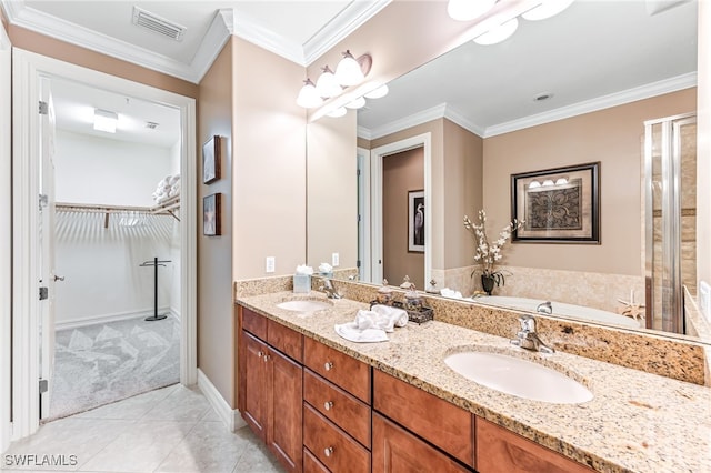 bathroom featuring crown molding, tile patterned floors, vanity, and a bathing tub