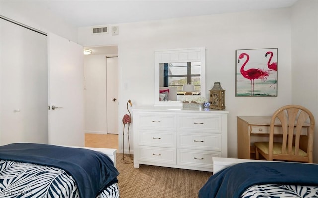 bedroom featuring light colored carpet