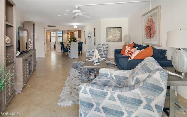 living room featuring light tile patterned floors and ceiling fan