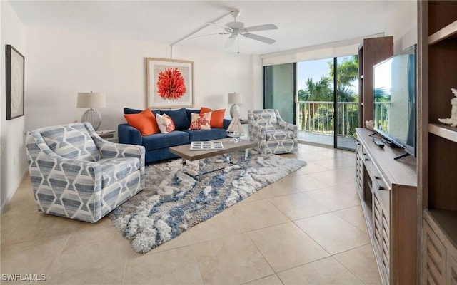 living room featuring light tile patterned floors, expansive windows, and ceiling fan