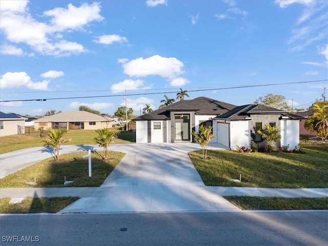 view of front of home featuring a garage and a front yard