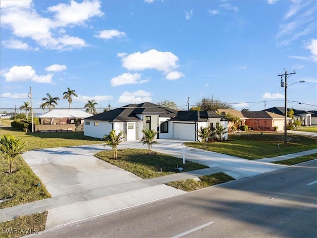 view of front facade with a garage and a front lawn