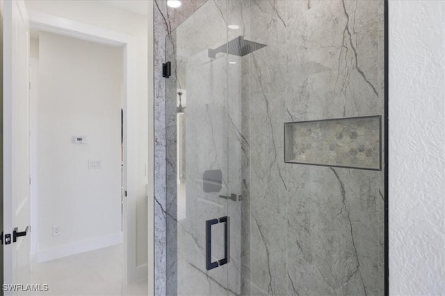 bathroom featuring a shower with shower door