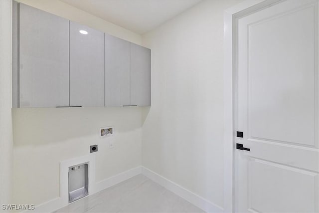 clothes washing area featuring washer hookup, cabinets, and hookup for an electric dryer