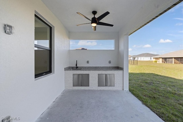 view of patio / terrace featuring ceiling fan