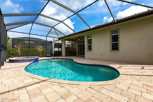 view of swimming pool with glass enclosure, a pool with connected hot tub, and a patio