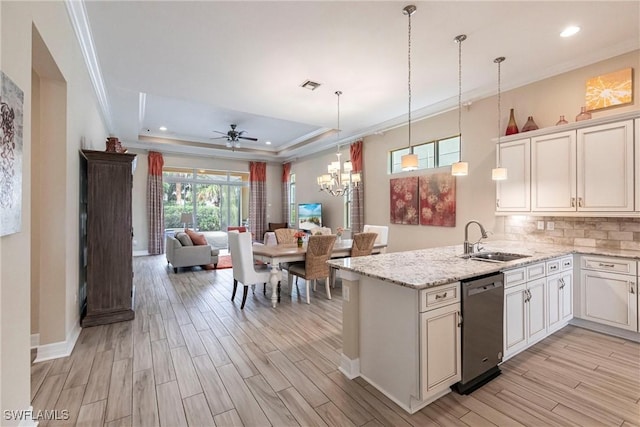 kitchen with a sink, visible vents, white cabinets, open floor plan, and dishwasher