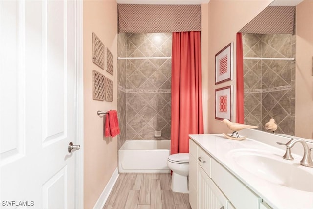 full bathroom featuring shower / tub combo with curtain, toilet, vanity, wood finished floors, and baseboards