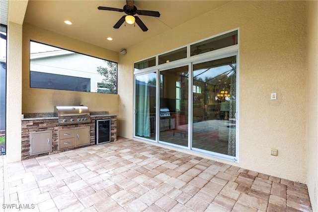 view of patio featuring a grill, beverage cooler, a ceiling fan, and area for grilling