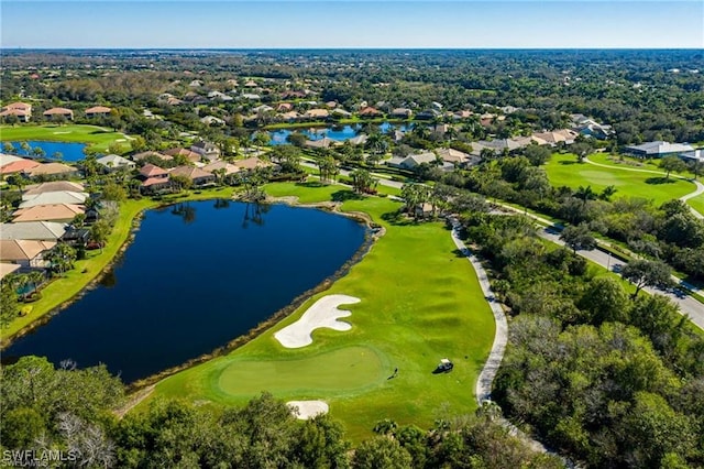 drone / aerial view with golf course view, a water view, and a residential view