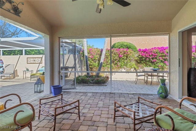 view of patio / terrace featuring a lanai and ceiling fan