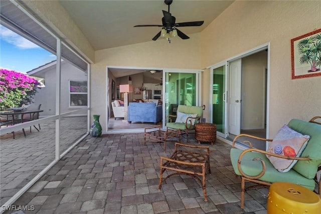 sunroom featuring ceiling fan and vaulted ceiling